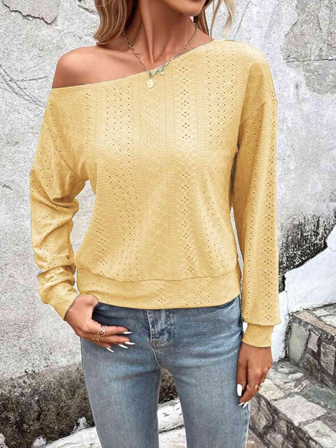 a woman wearing a yellow sweater and jeans