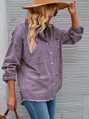 a woman wearing a hat and a purple shirt