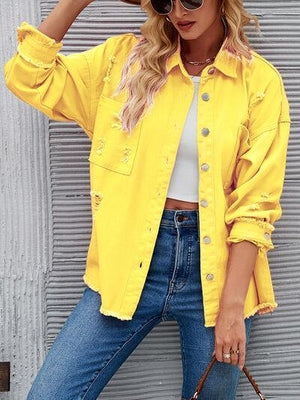 a woman wearing a yellow jacket and jeans