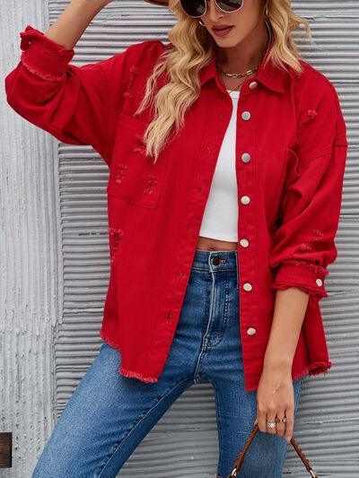 a woman wearing a red shirt and jeans