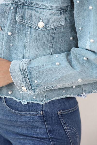 a close up of a person wearing a jean jacket