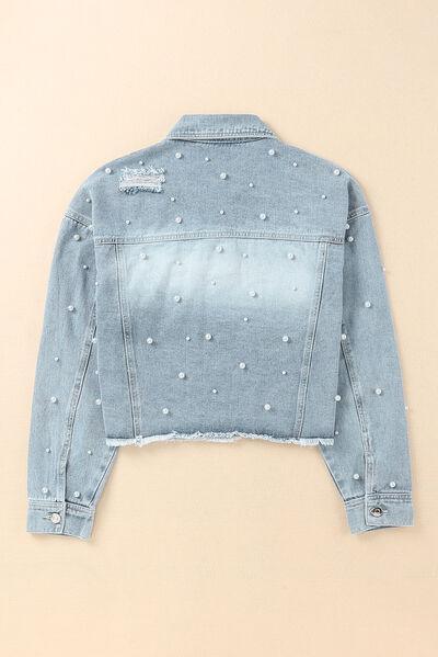 a denim jacket with pearls on the back