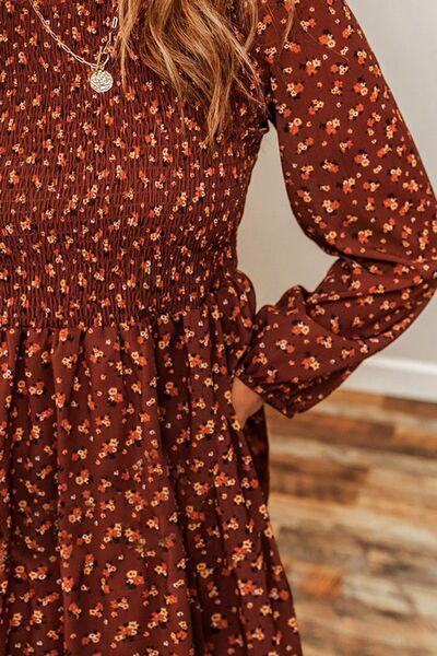 a woman wearing a brown floral print dress