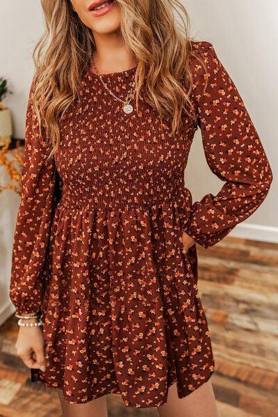 a woman wearing a brown floral print dress