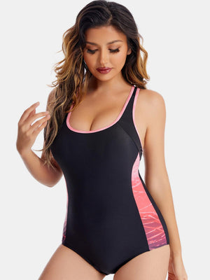 a woman in a black and pink swimsuit