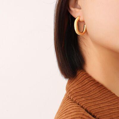 a close up of a person wearing a pair of earrings