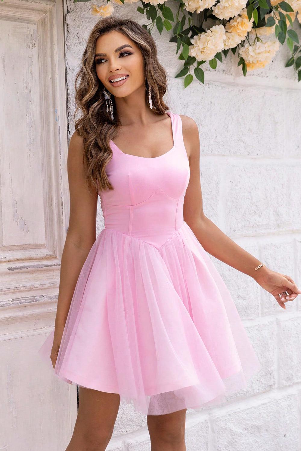 a woman in a pink dress posing for a picture