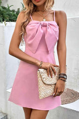 a woman in a pink dress holding a white purse