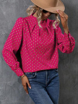 a woman wearing a hat and a pink shirt