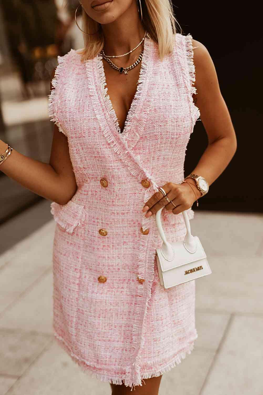a woman wearing a pink dress and a white purse
