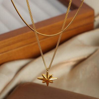 a gold necklace with a star on it