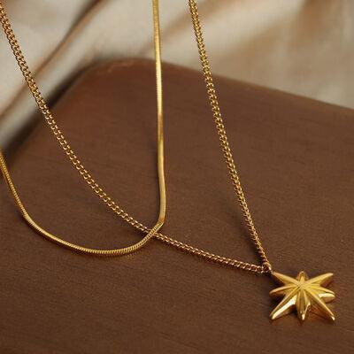 a gold necklace with a star on it