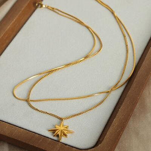 a necklace with a star on it in a wooden box