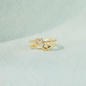 two gold rings on a white background