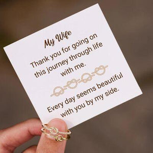 a person holding a card with a ring on it