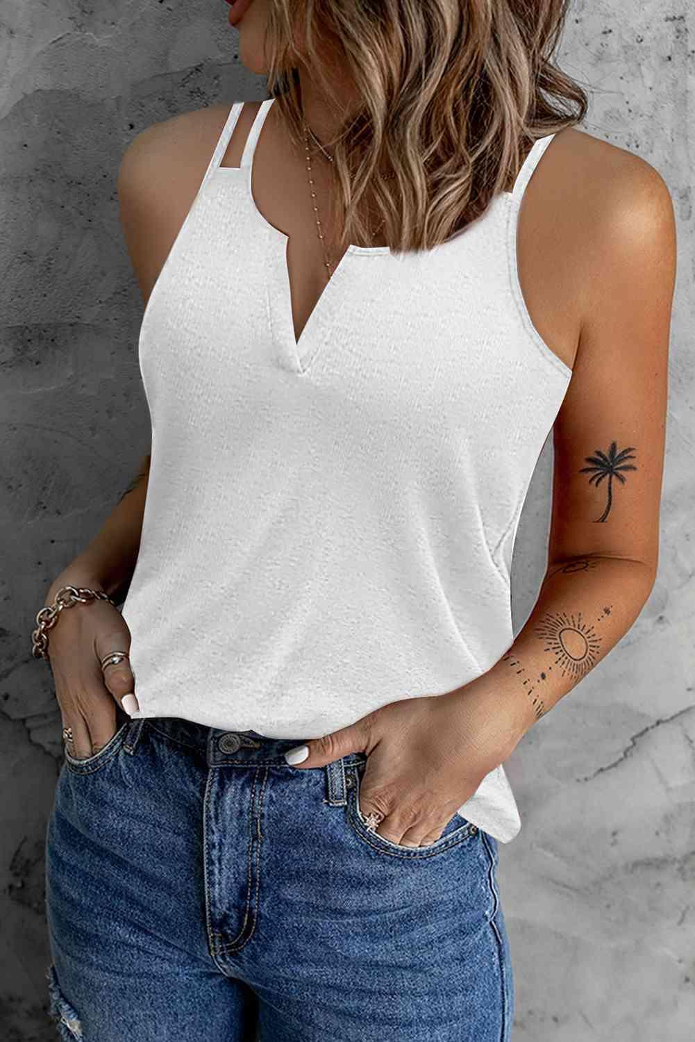 a woman wearing a white top and jeans