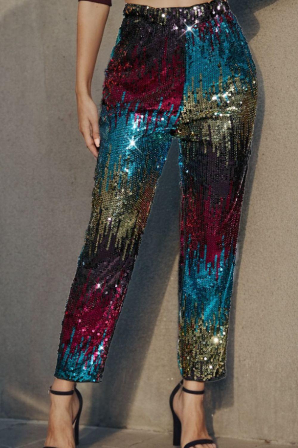 a woman in a crop top and sequin pants