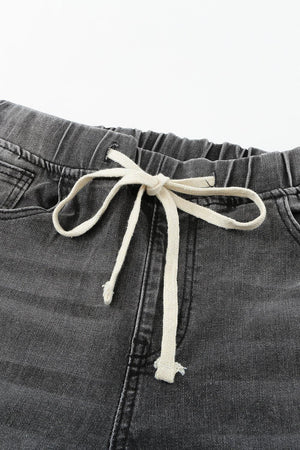 a close up of a pair of jeans with a tie