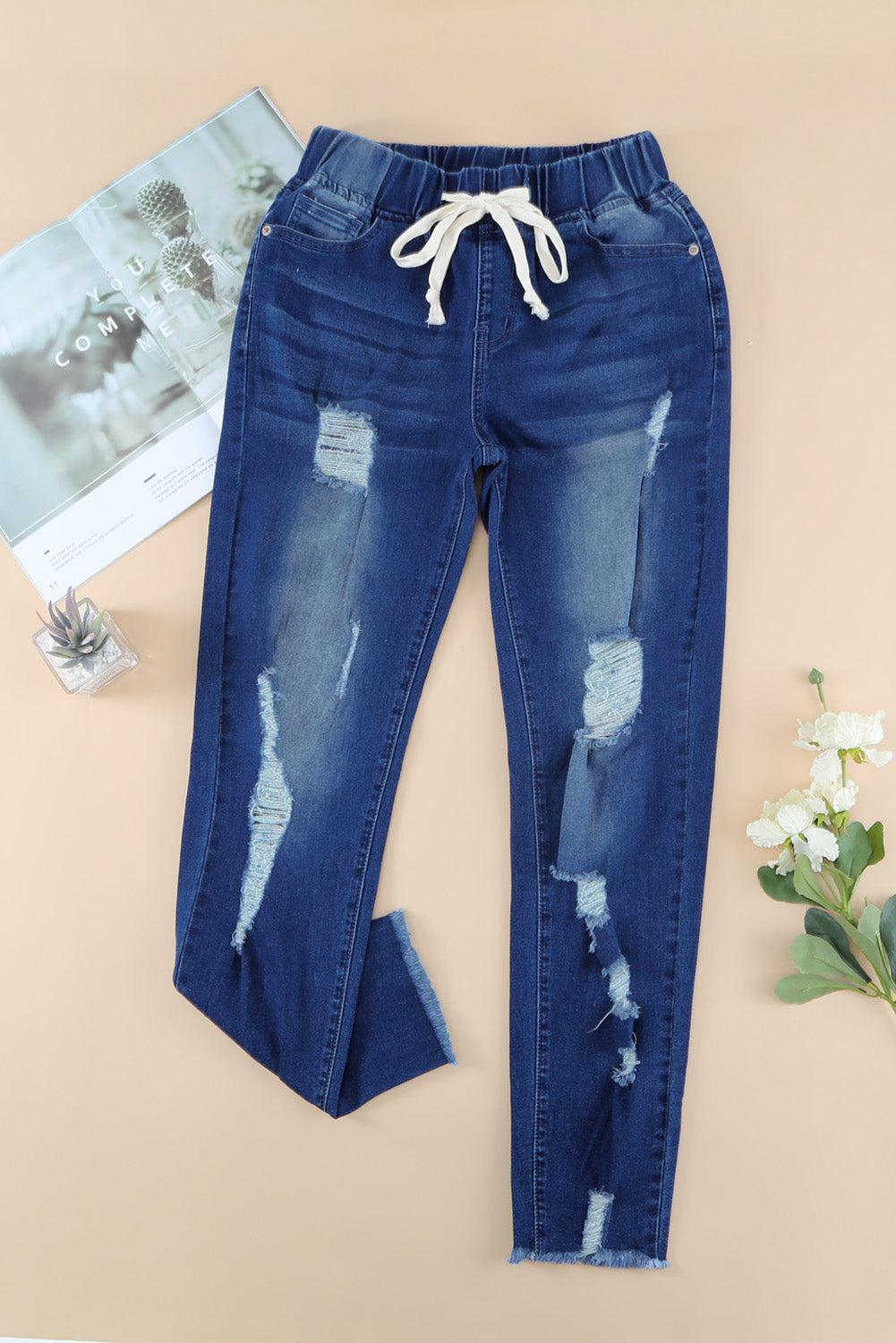 a pair of blue jeans with holes on them