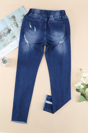 a pair of blue jeans with ripped knees