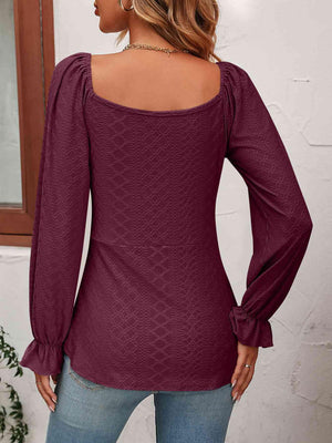 the back of a woman wearing a purple top