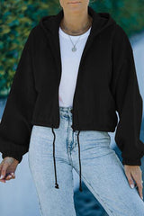 a woman wearing a black jacket and jeans