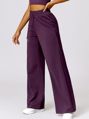 a woman in a crop top and wide legged pants