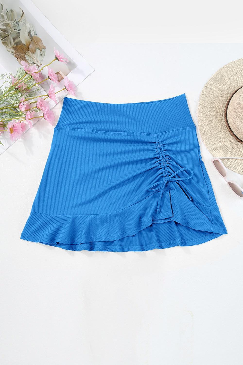 a women's blue skirt with a straw hat