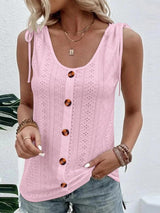 a woman wearing a pink tank top and jeans