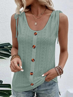 a woman wearing a green tank top with buttons