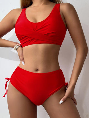 a woman in a red bikini top and shorts