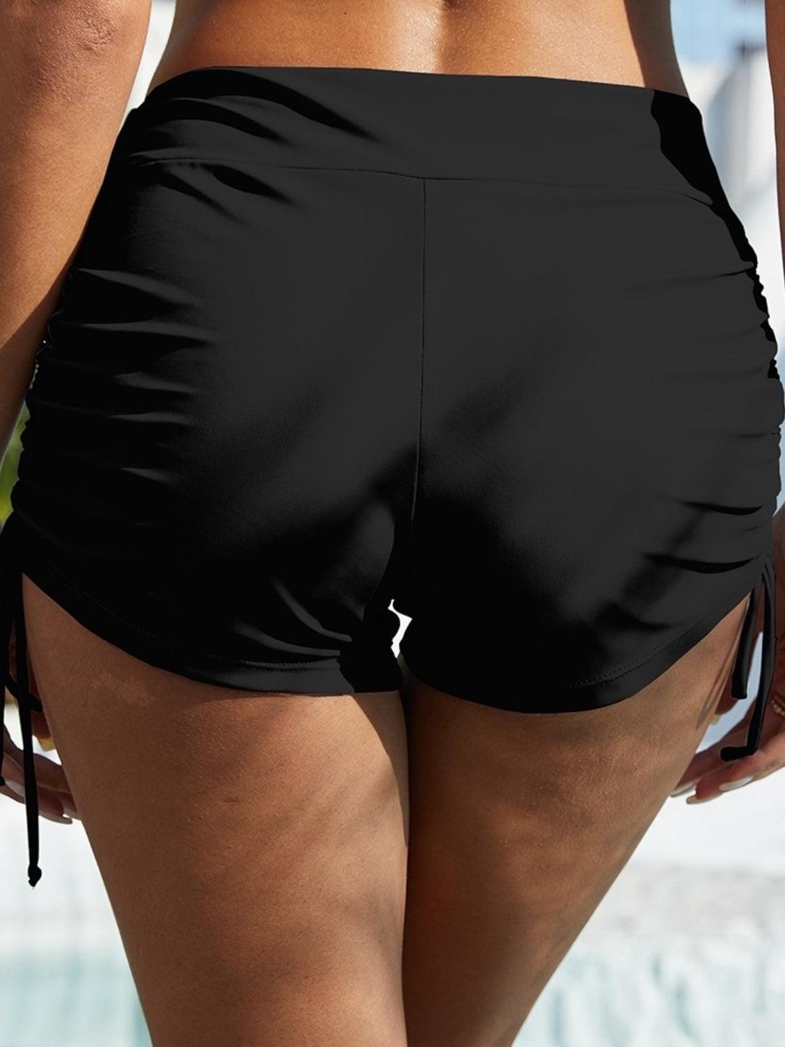 a close up of a woman's butt wearing a black swimsuit