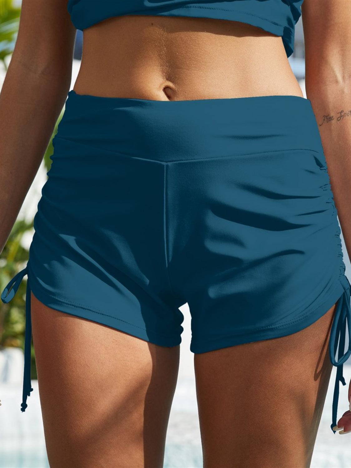 a close up of a person wearing a bikini top and shorts