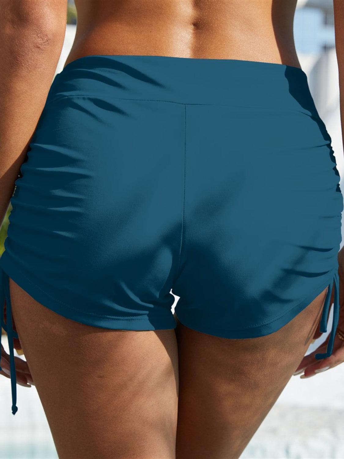 a close up of a person wearing a blue swimsuit