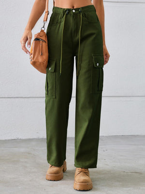 a woman wearing green pants and a crop top