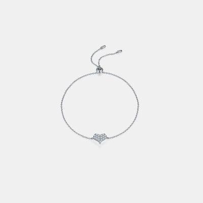 a silver bracelet with a heart charm on a white background