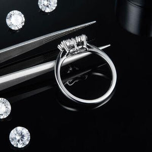 a pair of scissors and some diamonds on a table