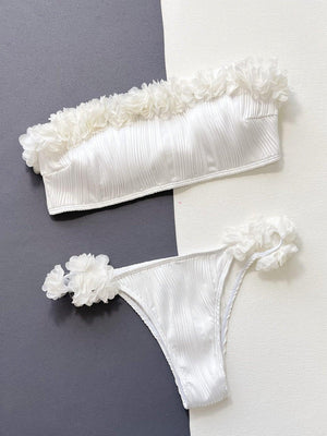 a pair of white garters with flowers on them