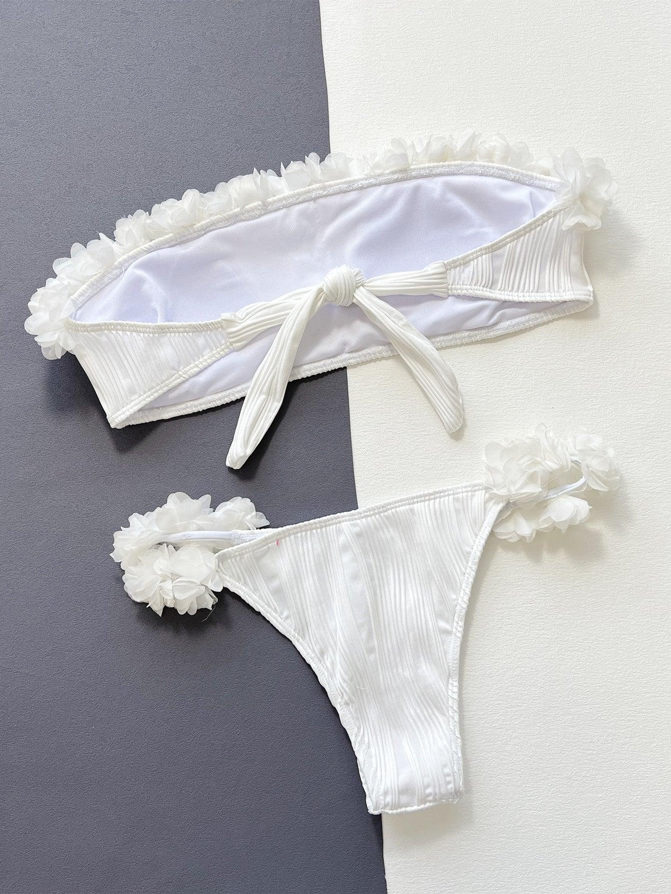 two pieces of white lingerie on a gray and white background