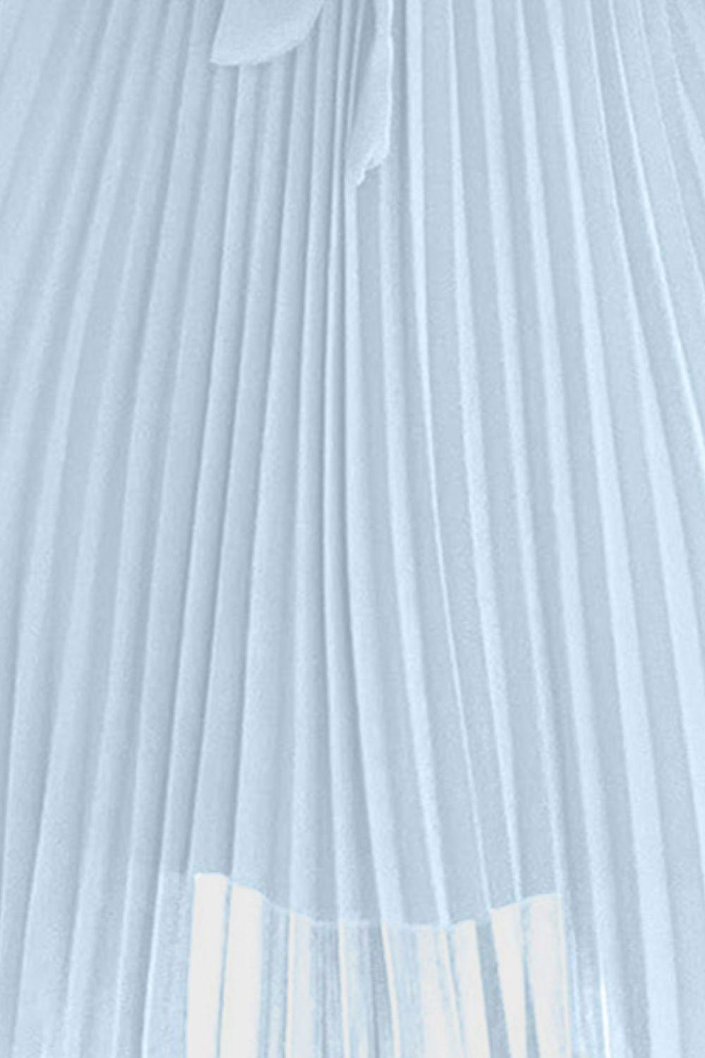 a white pleated skirt with a bow tie