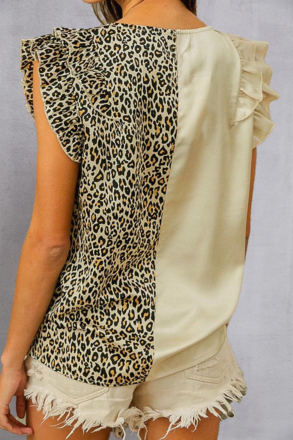 a woman wearing a top with a leopard print on it