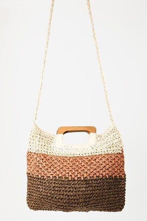 a brown and white purse hanging from a chain