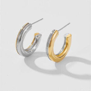 a pair of silver and gold hoop earrings