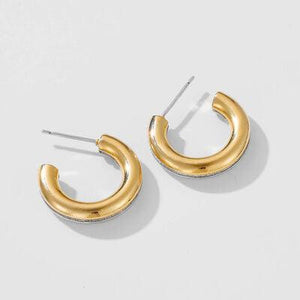 a pair of gold hoop earrings on a white background