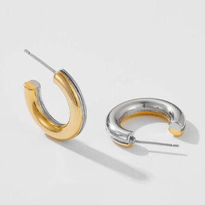 a pair of silver and gold hoop earrings