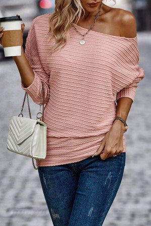 a woman in a pink top holding a cup of coffee