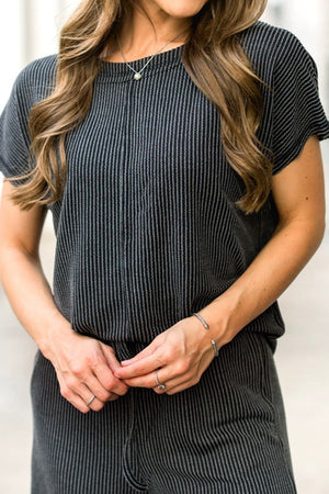 a woman wearing a black and white striped dress