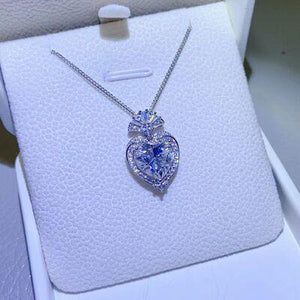 a heart shaped necklace in a white box