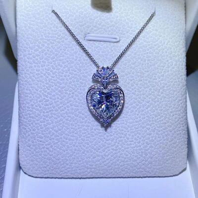 a blue heart shaped necklace in a white box