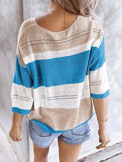 a little girl wearing a sweater and shorts